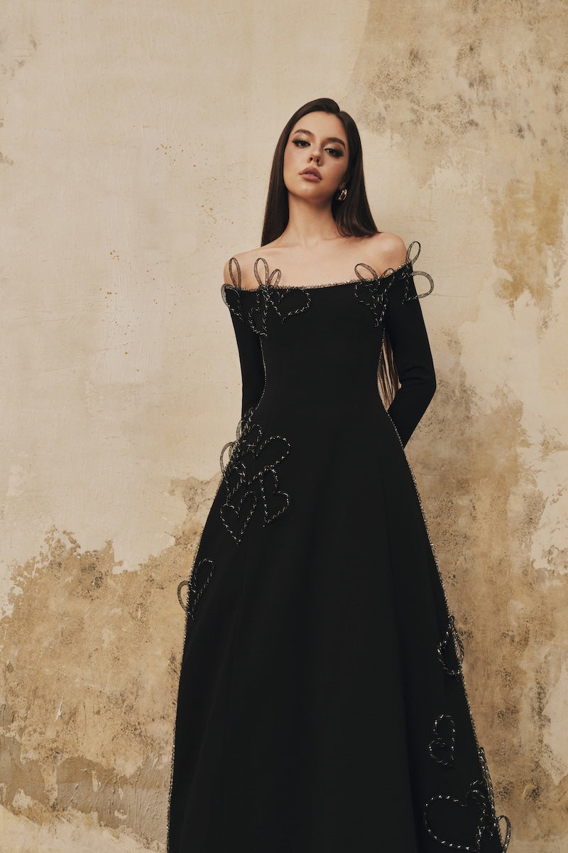 Black L'SCARLETT flared off-shoulder long-sleeve midi dress with heart beading, elegant and stylish for special occasions.