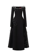 Black flared off-shoulder long-sleeve gown by L'SCARLETT with intricate heart beading on the front.