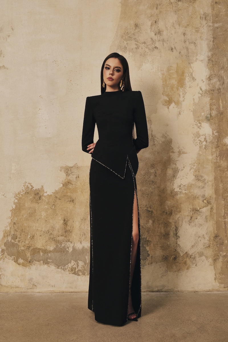 Black L'SCARLETT peplum high-neck long-sleeve maxi dress with crystal beading and front slit, elegant evening gown.