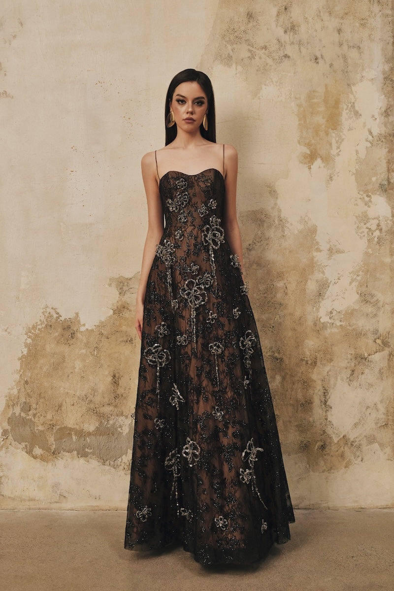 Black L'SCARLETT A-line spaghetti-strap maxi dress with 3D crystal floral embellishments, elegant and flowing for formal occasions.