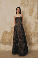 L'SCARLETT A-line spaghetti strap gown with 3D crystal floral embellishments, elegant evening dress with a flowing silhouette.