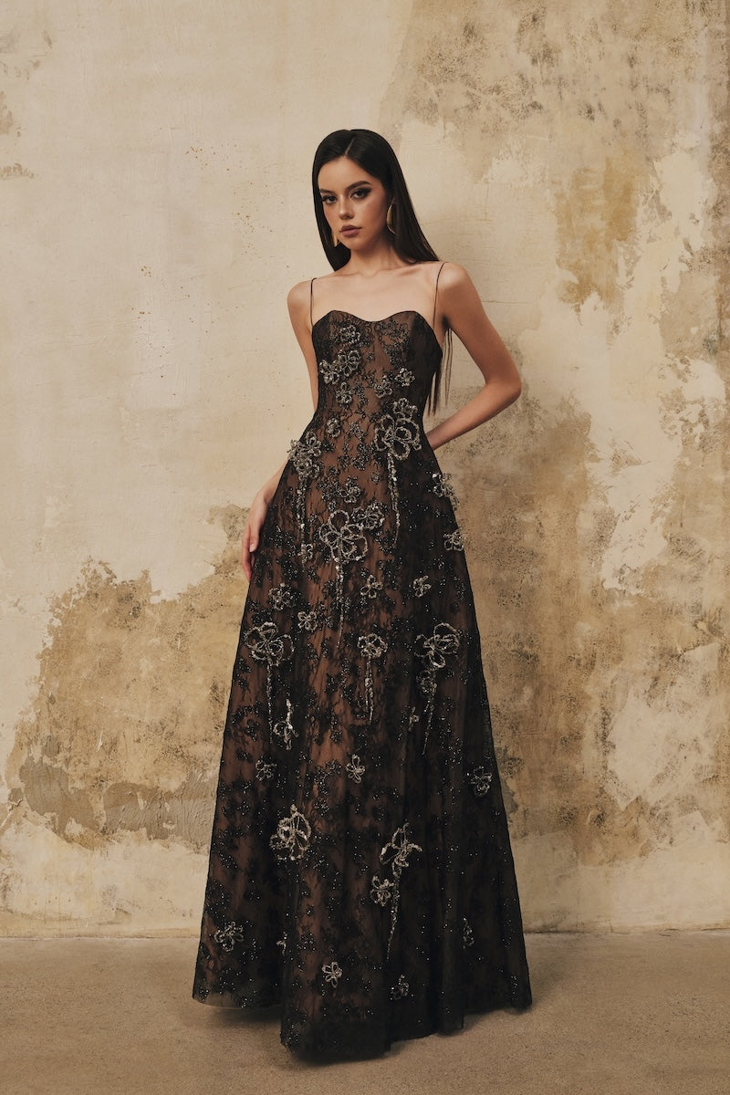 Black L'SCARLETT A-line spaghetti-strap maxi dress with 3D crystal floral details, elegant and flowing for special occasions.
