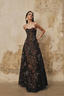 L'SCARLETT A-line spaghetti-strap gown featuring 3D crystal floral embellishments and elegant flowing fabric.