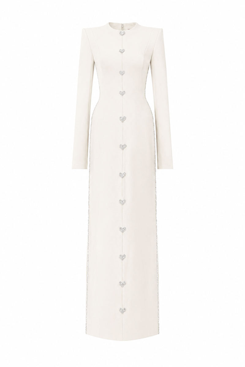 Off-white L'SCARLETT maxi dress with straight cut, long sleeves, hand-embellished crystal heart design, front view.