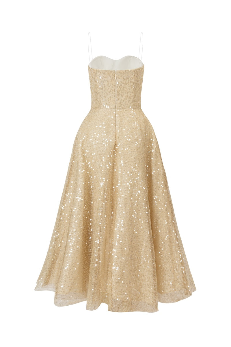 Back view of L'SCARLETT light gold flared spaghetti-strap sequin midi dress, showcasing its elegant silhouette and shimmering fabric.