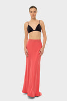 niLuu AQUAFLORA Lucy slip skirt in coral, a flowy maxi skirt with a relaxed fit and vibrant color, shown flat on a white background.