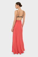 NiLuu AQUAFLORA Lucy slip skirt in coral, a flowy maxi skirt with a relaxed fit and vibrant color, shown on a model.