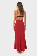 NiLuu Lucy slip skirt in rouge, a stylish maxi skirt with a flowy silhouette and vibrant red color, shown on a model.