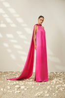 Luminous halter gown by Le Thanh Hoa featuring elegant design, flowing fabric, and stylish neckline for formal occasions.
