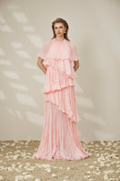 Le Thanh Hoa pink tiered gown featuring flowing fabric and layered design, perfect for elegant occasions.