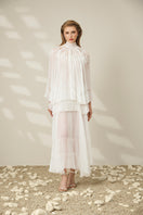 Le Thanh Hoa lace-trimmed pleated maxi dress with flowing fabric and elegant design, perfect for formal or casual occasions.
