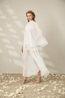 Lace-trimmed pleated maxi dress by Le Thanh Hoa featuring flowing fabric and elegant design, showcased on a model.