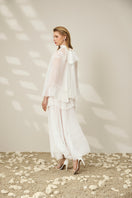 Elegant lace-trimmed pleated maxi dress by Le Thanh Hoa featuring flowing fabric and a stylish, feminine silhouette.