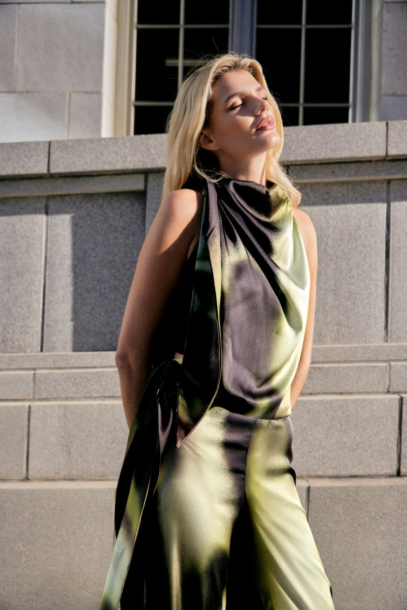 Green print Lumara blouse by Tinta Latina, stylish tops with vibrant pattern, displayed on a hanger.