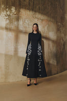 L'SCARLETT flared long-sleeve maxi dress with 3D crystal floral embellishments, flowing fabric, and elegant design.