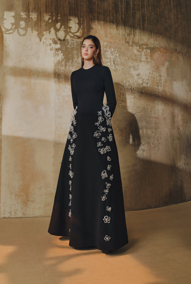 L'SCARLETT flared long-sleeve maxi dress with 3D crystal floral embroidery, elegant and flowing design, front view.