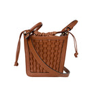 ISIDORA MALVA La Dorada Mini brown top handle bag with structured design and sleek finish on smooth leather surface.