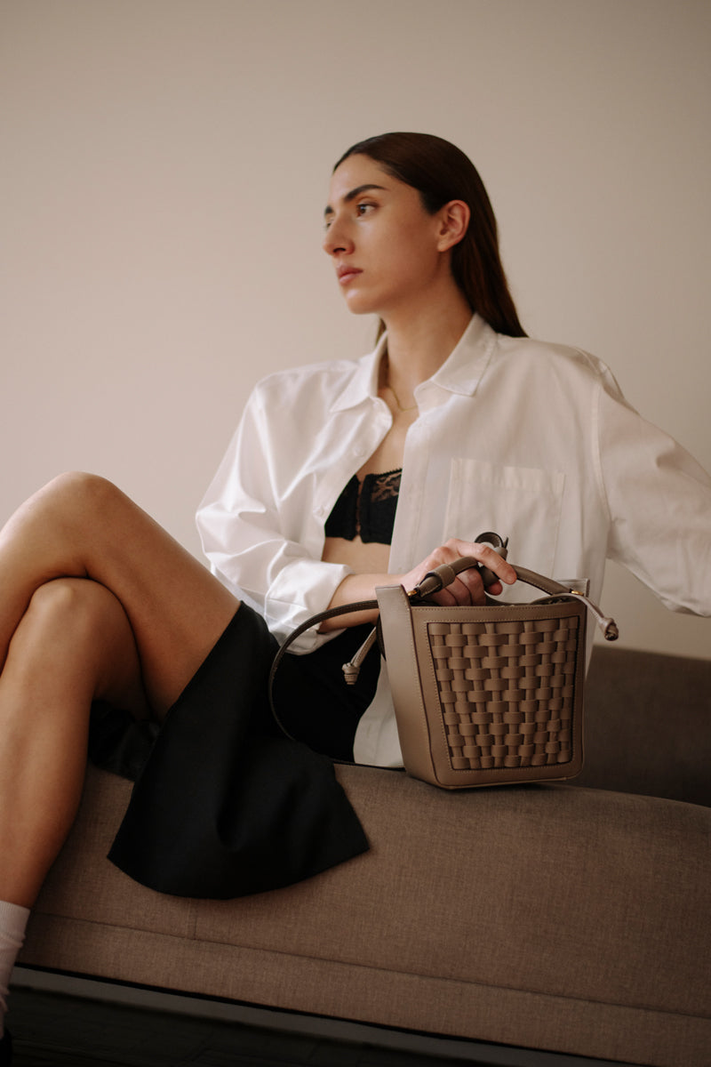 ISIDORA MALVA La Dorada Mini taupe top handle bag with sleek design and gold-tone hardware.