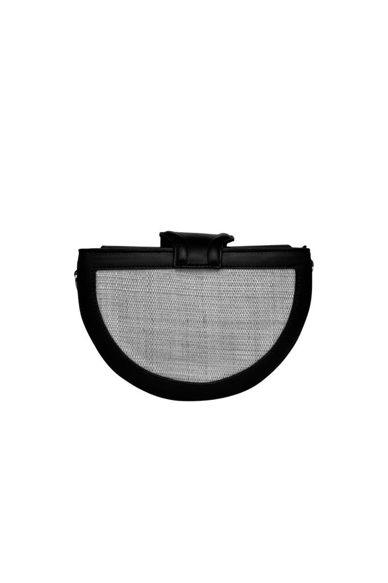 Black ISIDORA MALVA Luna clutch with sleek design and compact size, shown with a shoulder strap for versatile style.