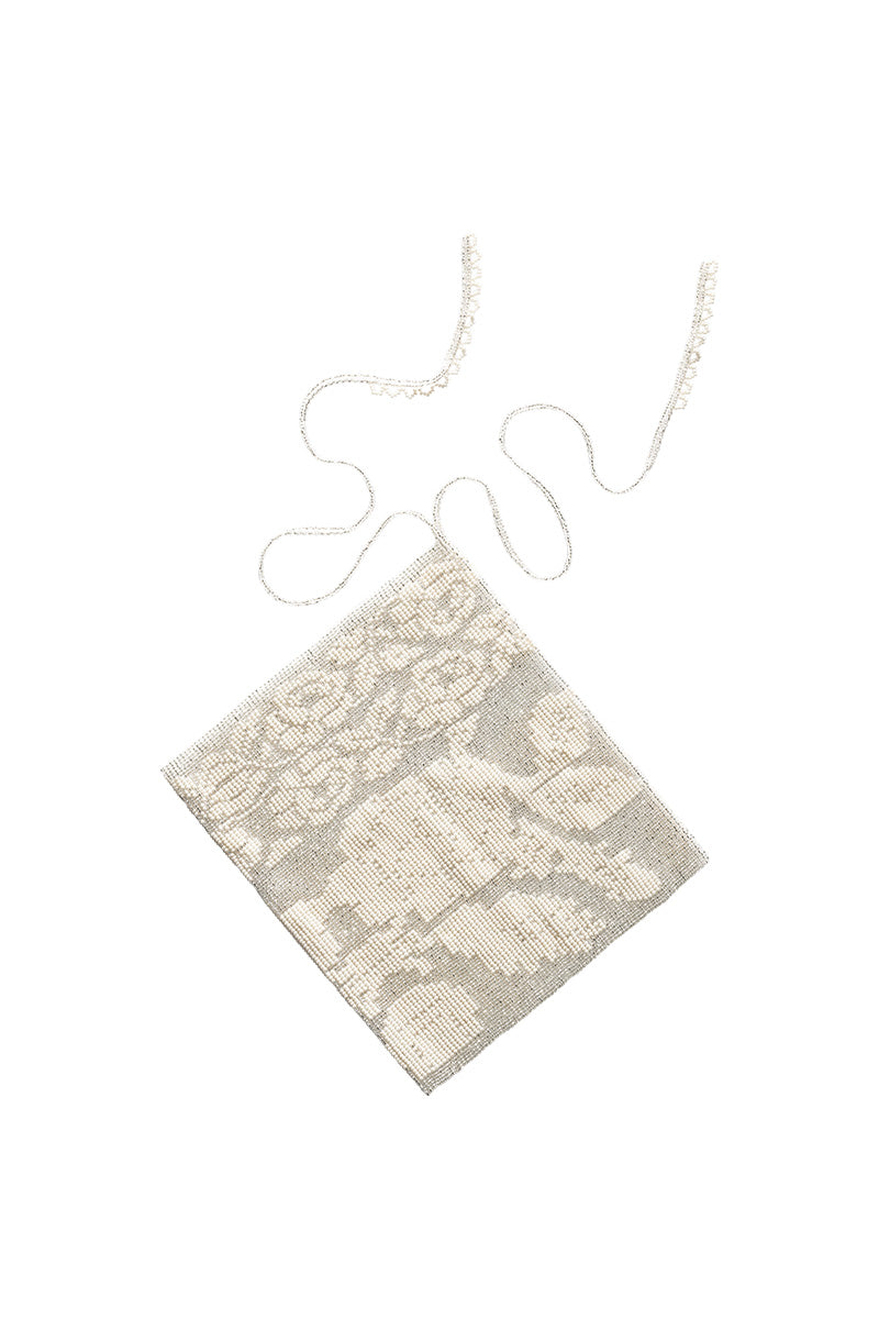 White lace hair scarf by Pura Utz, featuring delicate crochet details, styled as a fashionable hair accessory.