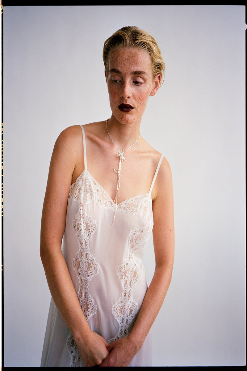 Silver dandelion tie bolo necklace by Pura Utz featuring delicate lace-inspired design and adjustable cord.