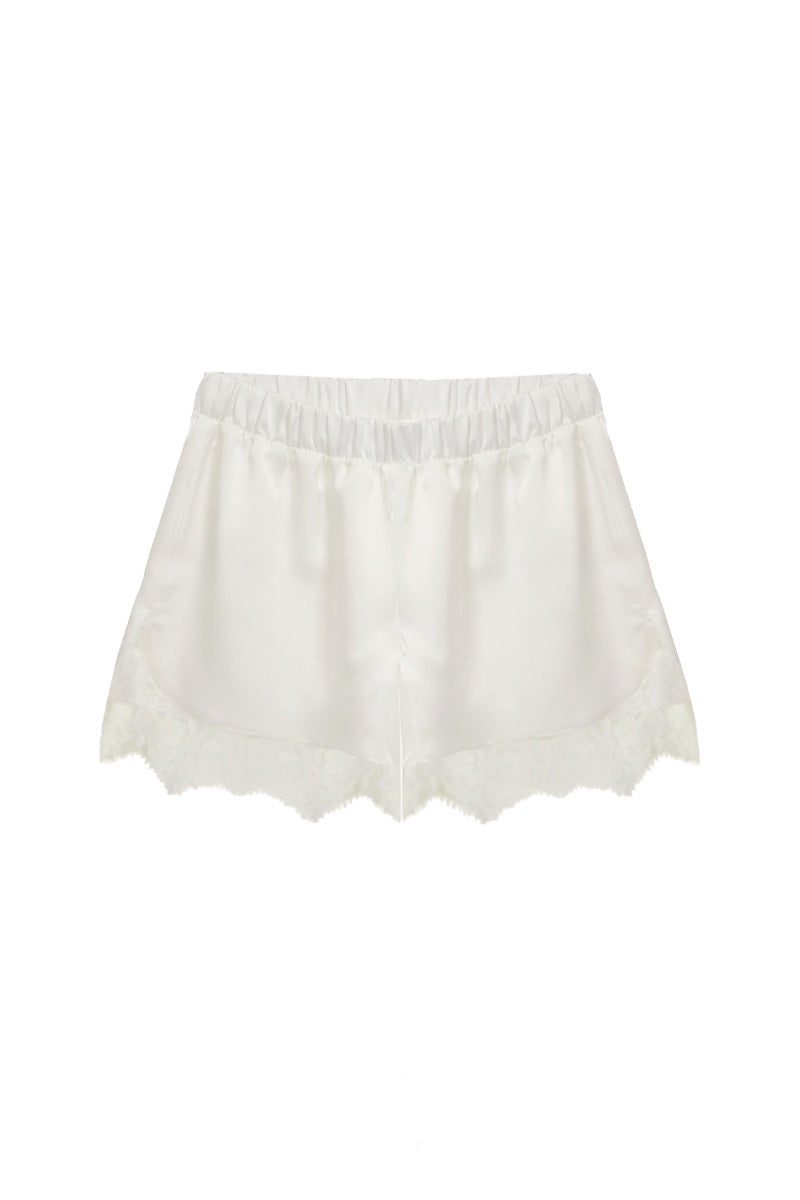 Ivory silky shorts with lace trim by Kris Marán, showcasing smooth fabric and delicate lace detailing.