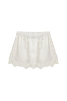 Ivory silky shorts with lace trim by Kris Marán, showcasing smooth fabric and delicate lace detailing.