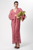 Pink metallic hand-knit coat by Lalo, showing its cozy textured fabric and stylish design.