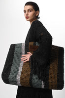 Black metallic knit coat by Lalo, showcasing a stylish hand-knit design with a cozy, textured appearance.