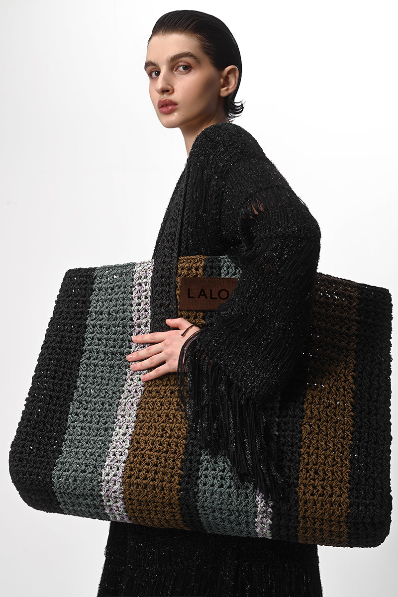 Black metallic knit coat by Lalo, showcasing a stylish hand-knit design with a cozy, textured appearance.