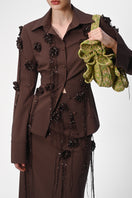 Lalo maxi pencil skirt with knitted floral patterns, featuring a fitted silhouette and decorative flower details.