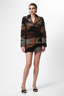 Lalo hand-knit shaped brown multi-colored jacket, cozy and stylish, displayed on a hanger with detailed knit patterns.