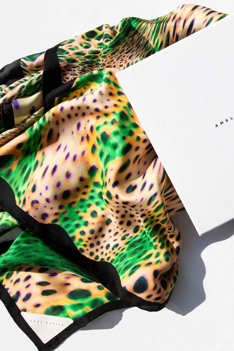 Amel Batita Lamazon Moussard silk scarf featuring a vibrant, intricate pattern on a smooth, luxurious fabric.