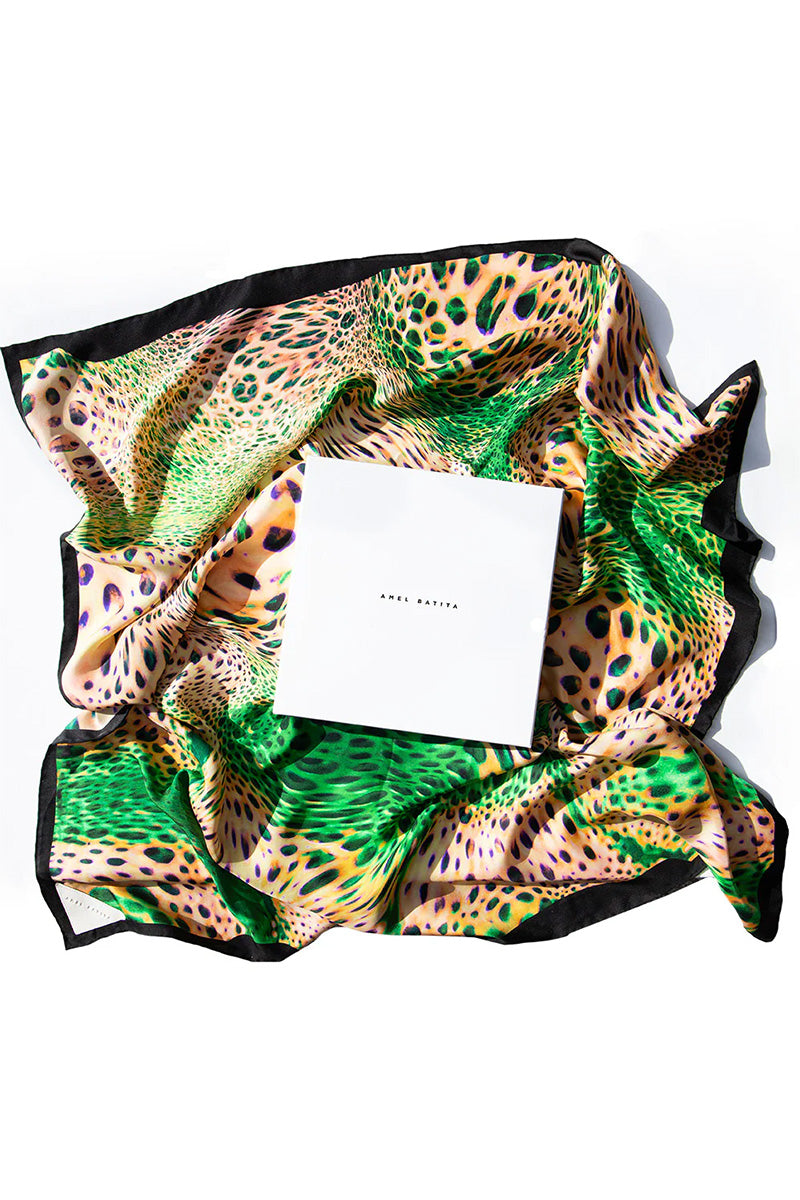 Amel Batita Lamazon Moussard silk scarf featuring intricate patterns and vibrant colors, displayed on packaging.