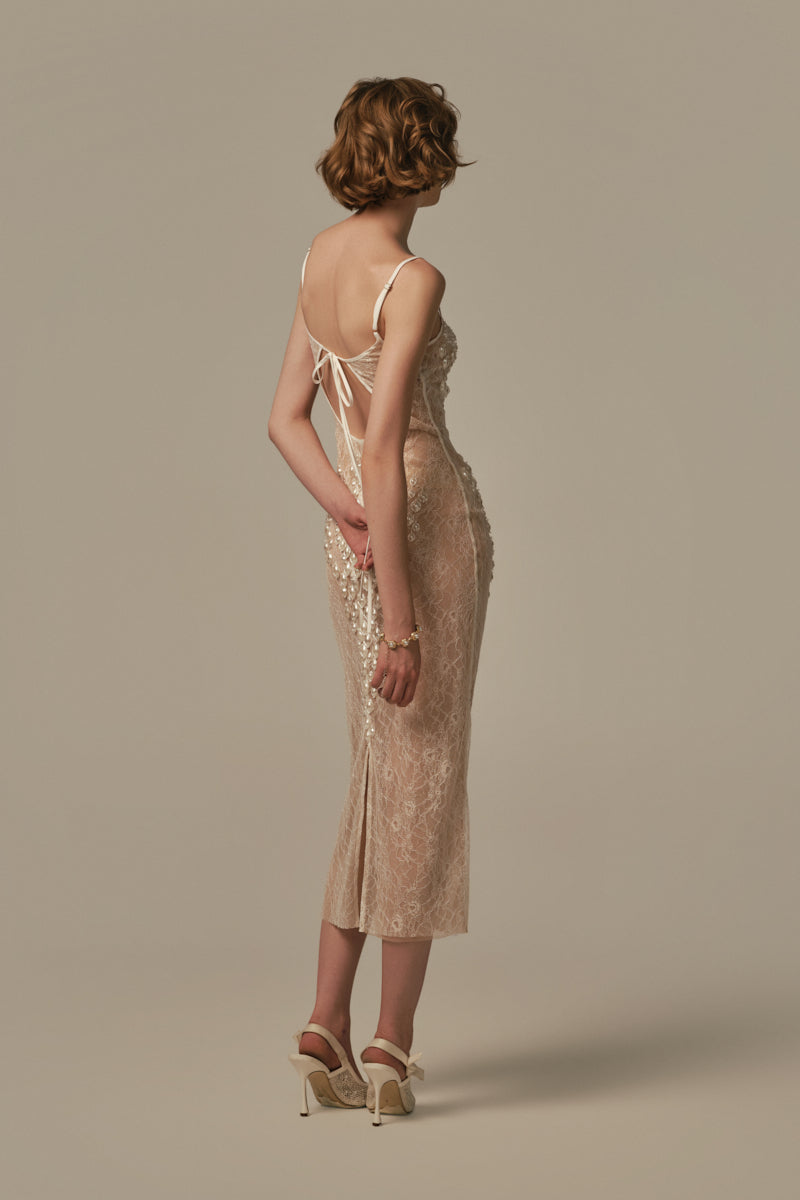 White POEM LARME midi dress on a model, showcasing a stylish, elegant knee-length dress with a fitted waist and flowy skirt.