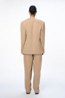 URABlazer Leah camel blazer shown on a model, featuring tailored fit and classic lapel design in a warm camel color.