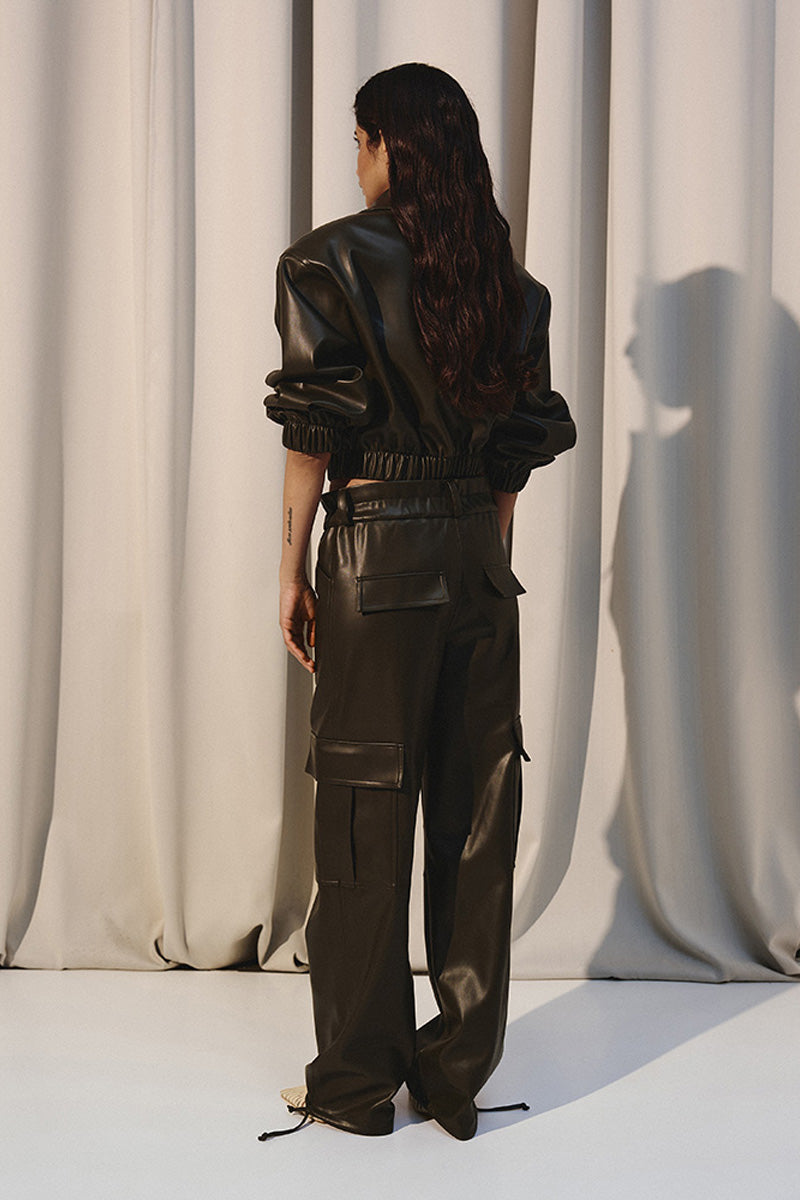 Green leather cropped bomber jacket by Kris Marán, featuring a stylish short design and classic bomber details.