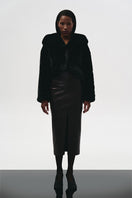 Brown leather midi skirt by Kris Marán, shown with front cut detail, styled for a chic, modern look.