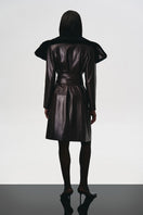 Brown leather trench coat with a fur collar by Kris Marán, showcasing a stylish and sophisticated outerwear design.