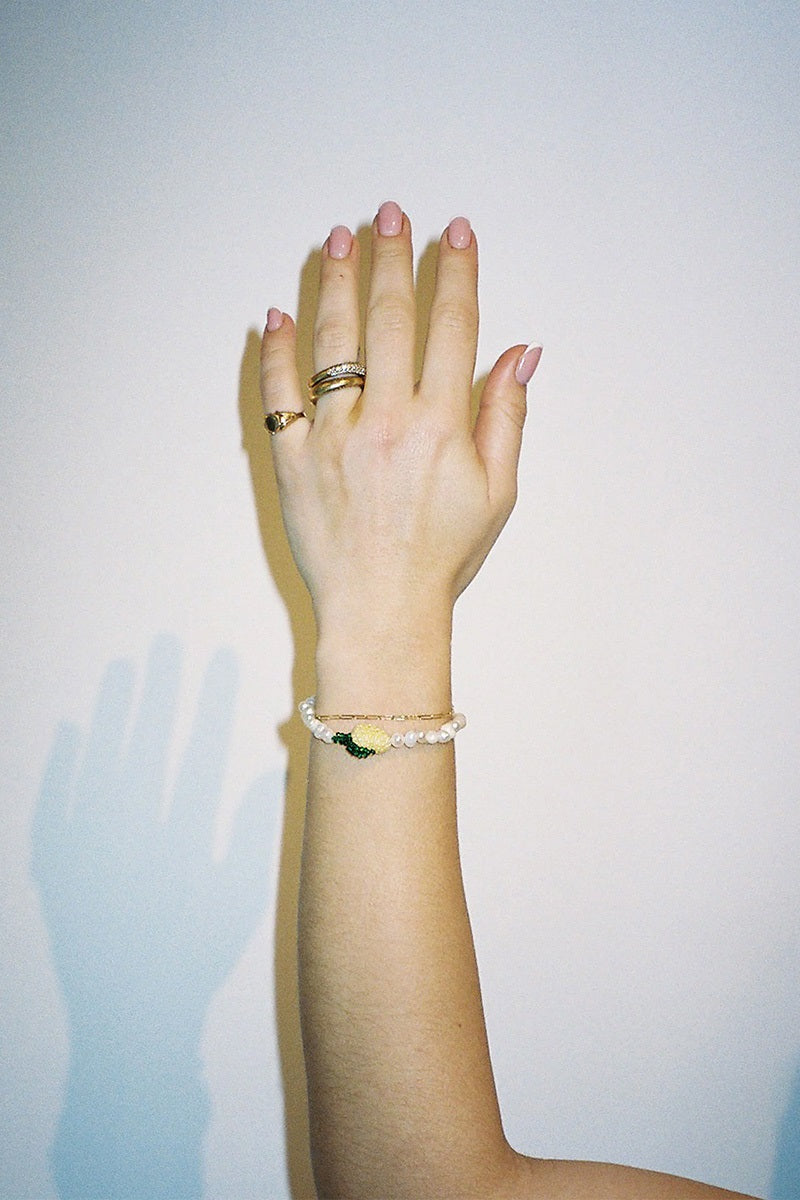 Pura Utz Pearl Lemon Bracelet featuring yellow lemon-shaped pearls on a delicate bracelet for a fresh, stylish look.