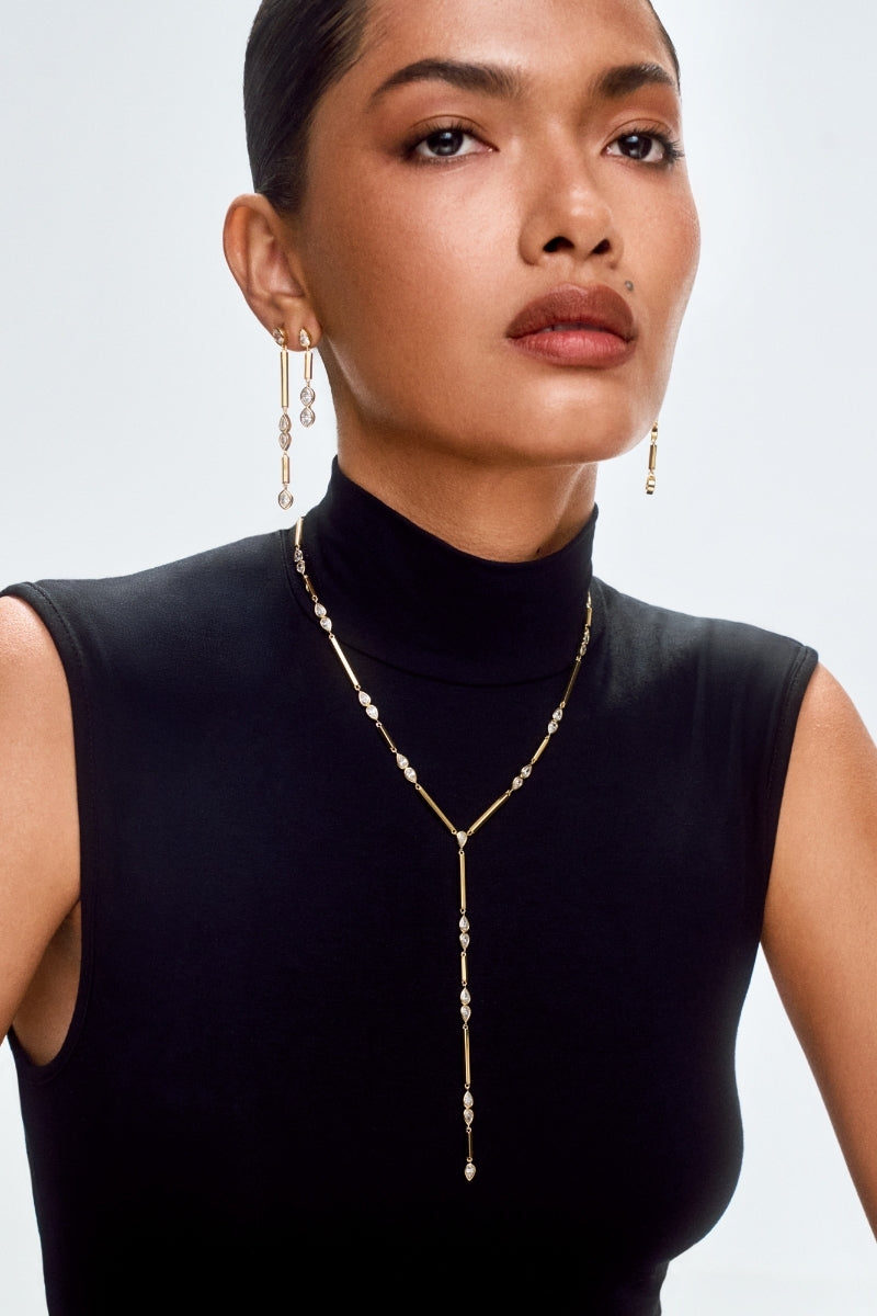 Gold Lia HEX Drop Earrings Medium by Velvet Desert, featuring geometric hexagon design and elegant drop style.