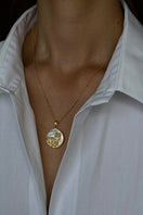 Freya Rose Aquarius zodiac necklace with 18ct gold plating, stylish jewelry displayed in a lifestyle setting.