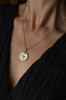 Gold plated Gemini zodiac necklace by Freya Rose featuring a delicate chain and zodiac pendant, styled on a model.
