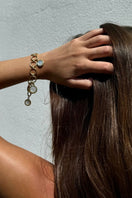 Freya Rose forged circular gold bracelet worn as jewelry, showcasing a stylish accessory with a sleek, modern design.