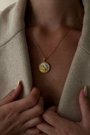 Freya Rose Capricorn 18ct gold plated zodiac necklace worn as jewelry in a lifestyle setting, showcasing a stylish gold pendant.