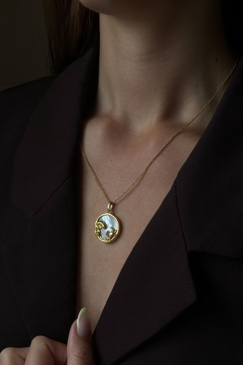 Gold-plated Cancer zodiac necklace by Freya Rose displayed on a model, featuring a pendant with the Cancer symbol on a sleek chain.