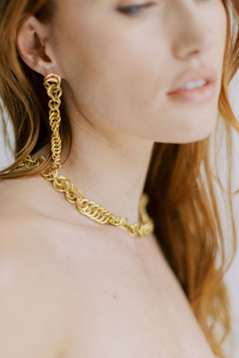 Freya Rose Sumba versatile gold earrings, stylish and elegant, shown in a lifestyle setting with a close-up of the jewelry.