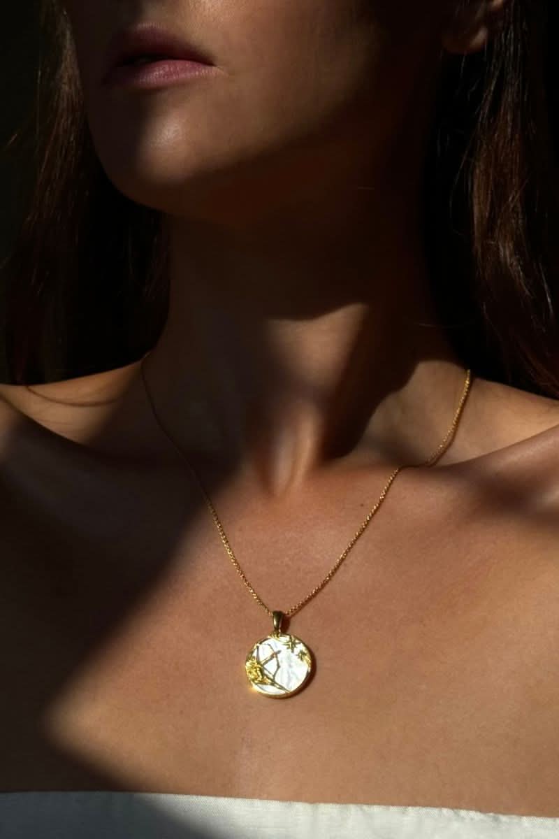 Sagittarius 18ct gold plated zodiac necklace by Freya Rose, featuring a delicate pendant worn with a casual outfit.