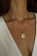 Libra zodiac necklace by Freya Rose featuring 18k gold-plated pendant on a delicate chain, worn as everyday jewelry.