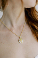 Freya Rose Aries zodiac necklace with 18ct gold plating, featuring a delicate pendant worn on a chain in a lifestyle setting.
